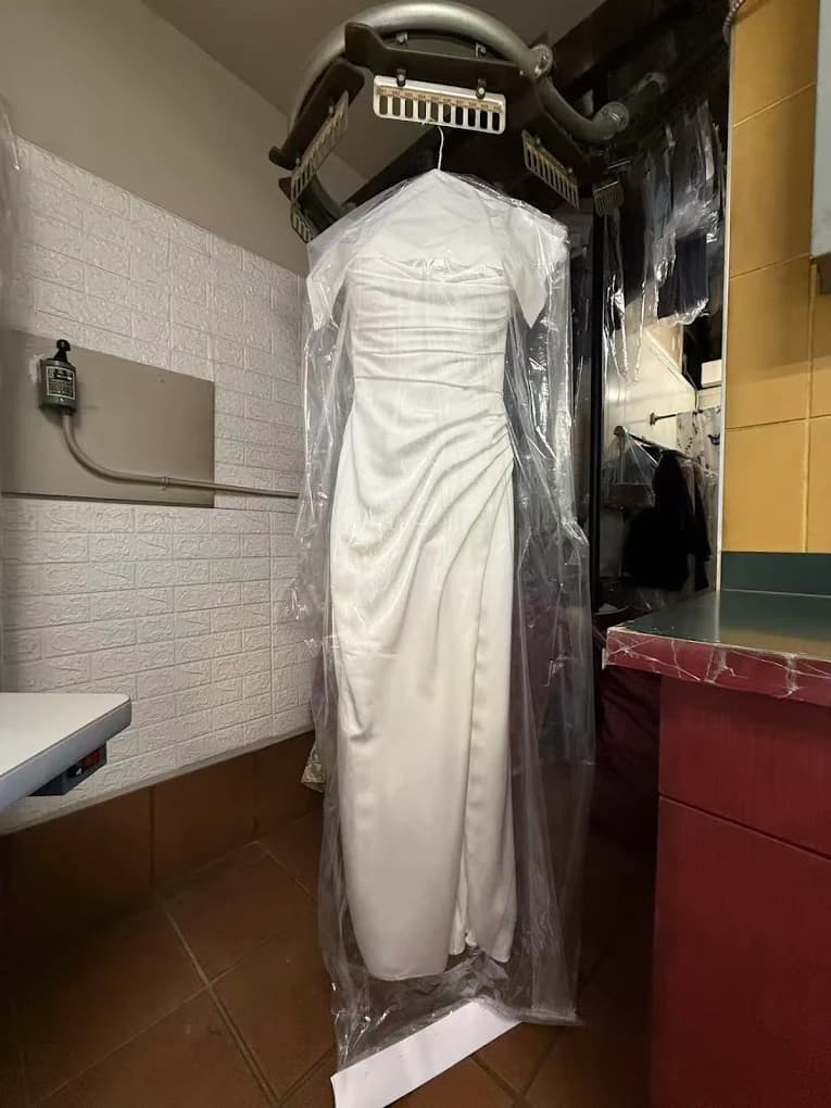 A wedding gown cleaned and sealed in a protective garment cover at The Dry Cleaner